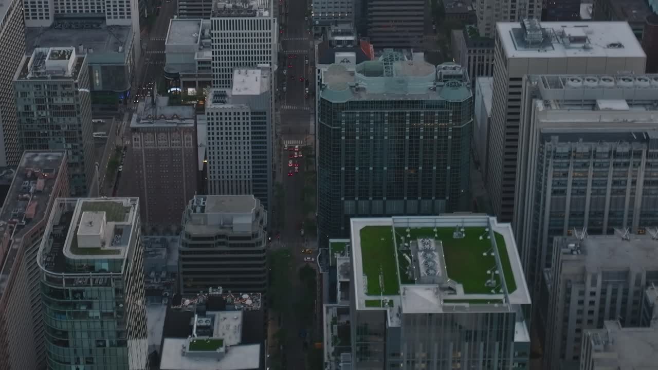 The scene shows an aerial view of downtown Chicago at dusk