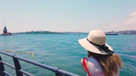 slow motion:beautiful girl takes pictures of bosphorus and maidens tower in uskudar town,istanbul,turkey