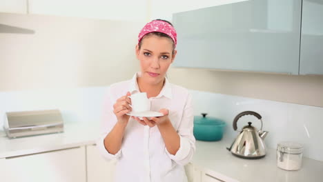 una hermosa morena bebiendo una taza de café