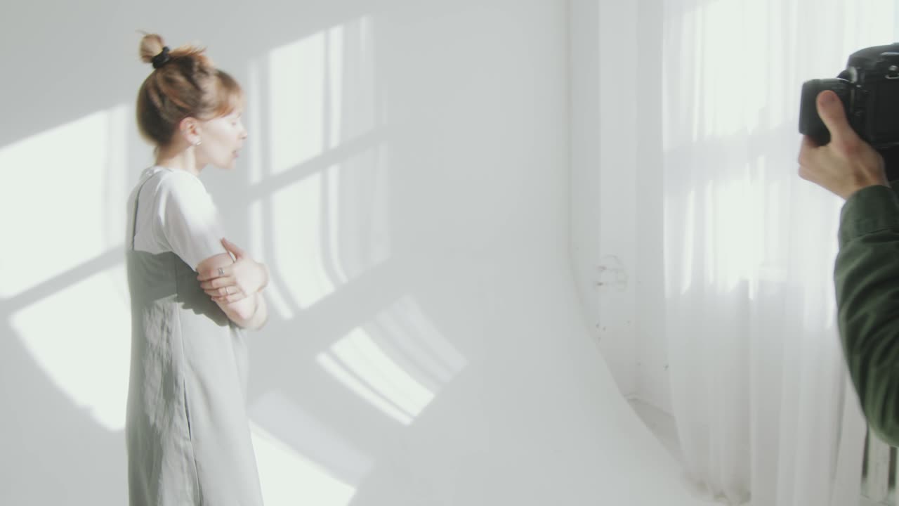 Photographer Working with Female Model during Photo Session in Studio
