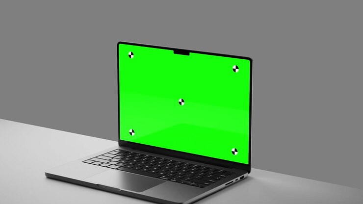 Laptop con schermo verde e marcatori di tracciamento su scrivania