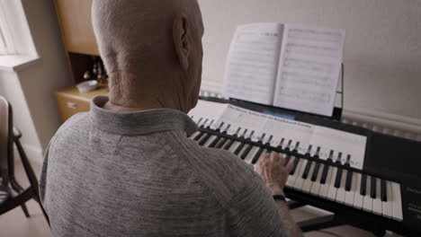 elderly man playing piano