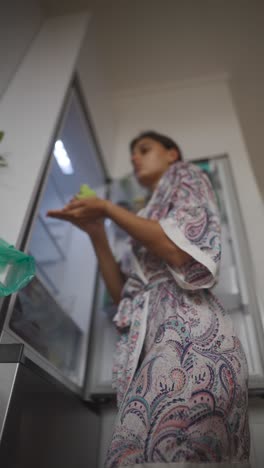 woman in a floral robe preparing food