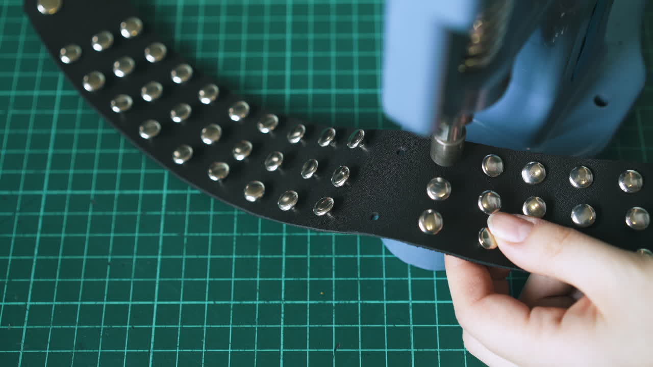 Experienced worker sets metal holnitens in black choker
