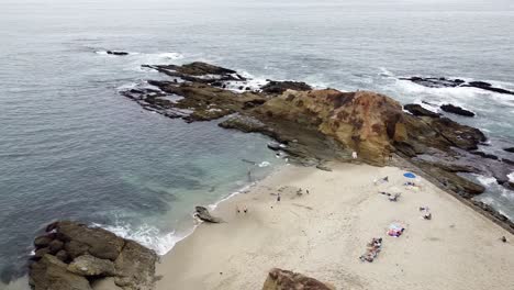 aerial view of laguna beach, calm waves washing ashore