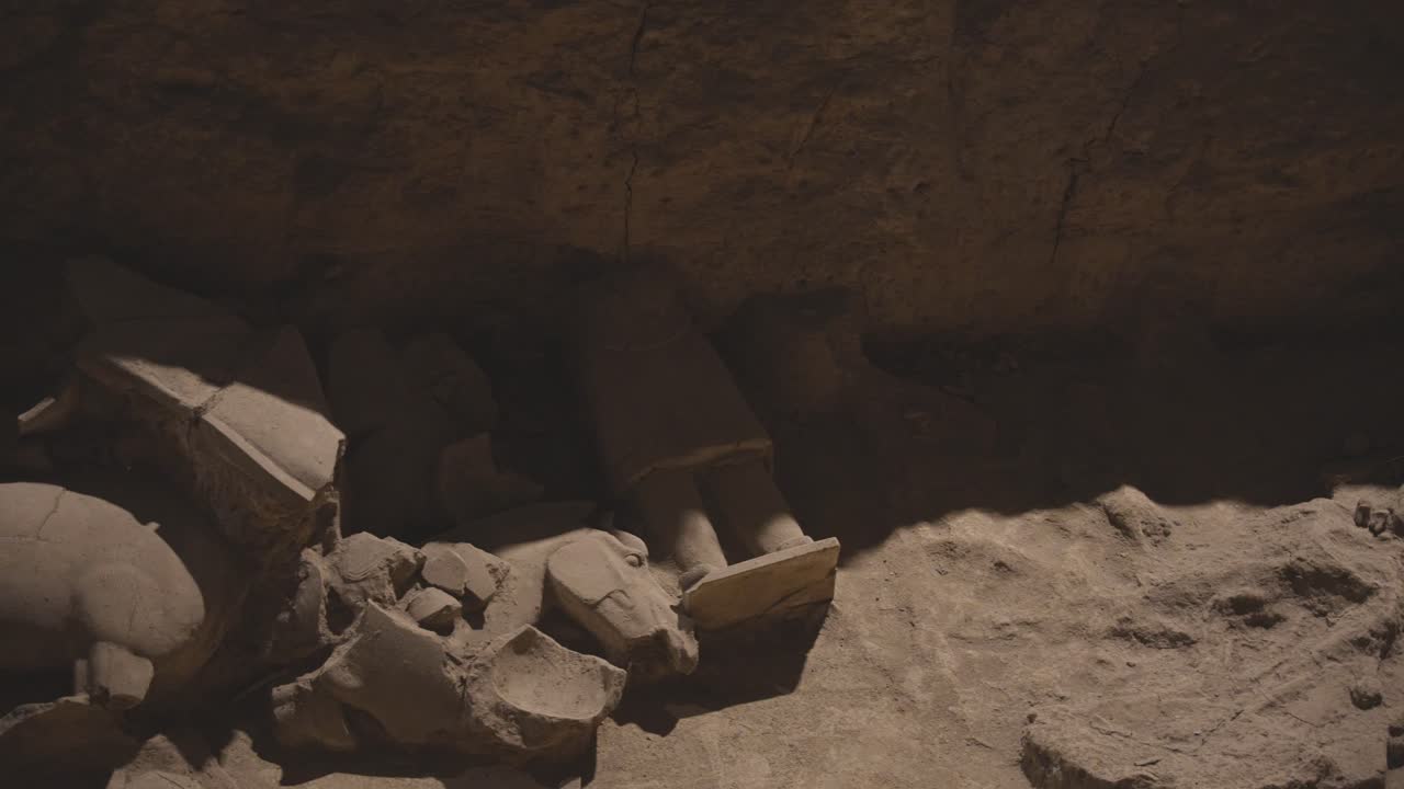 Broken parts of unexcavated Terracotta Army soldiers and horses in a pit. Xian, China