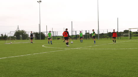 soccer players practicing teamwork on outdoor field, focusing on passing skills