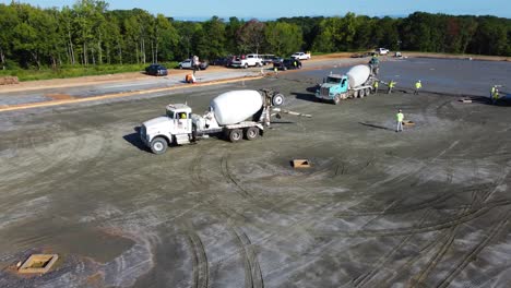 A-worker-guides-a-concrete-mixing-truck-into-position-at-a-construction-site