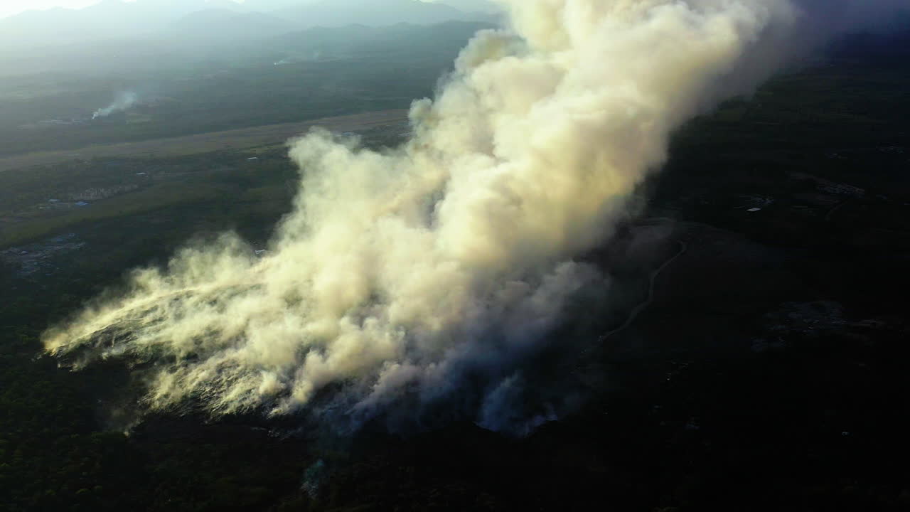 Aerial view around a white smoke cloud caused by a bushfire, Pollution, Global warming and Climate change, in New south Wales, Australia - orbit, drone shot over