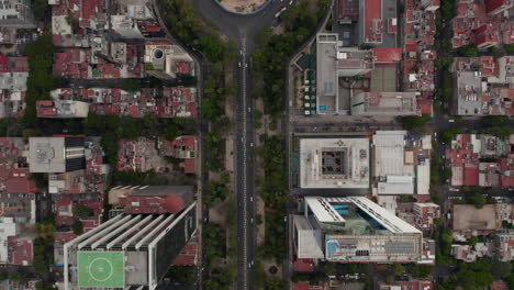 Aerial-birds-eye-overhead-top-down-view-of-traffic-in-wide-city-street.-Multilane-roundabout-crossroad-from-height.-Mexico-City,-Mexico.