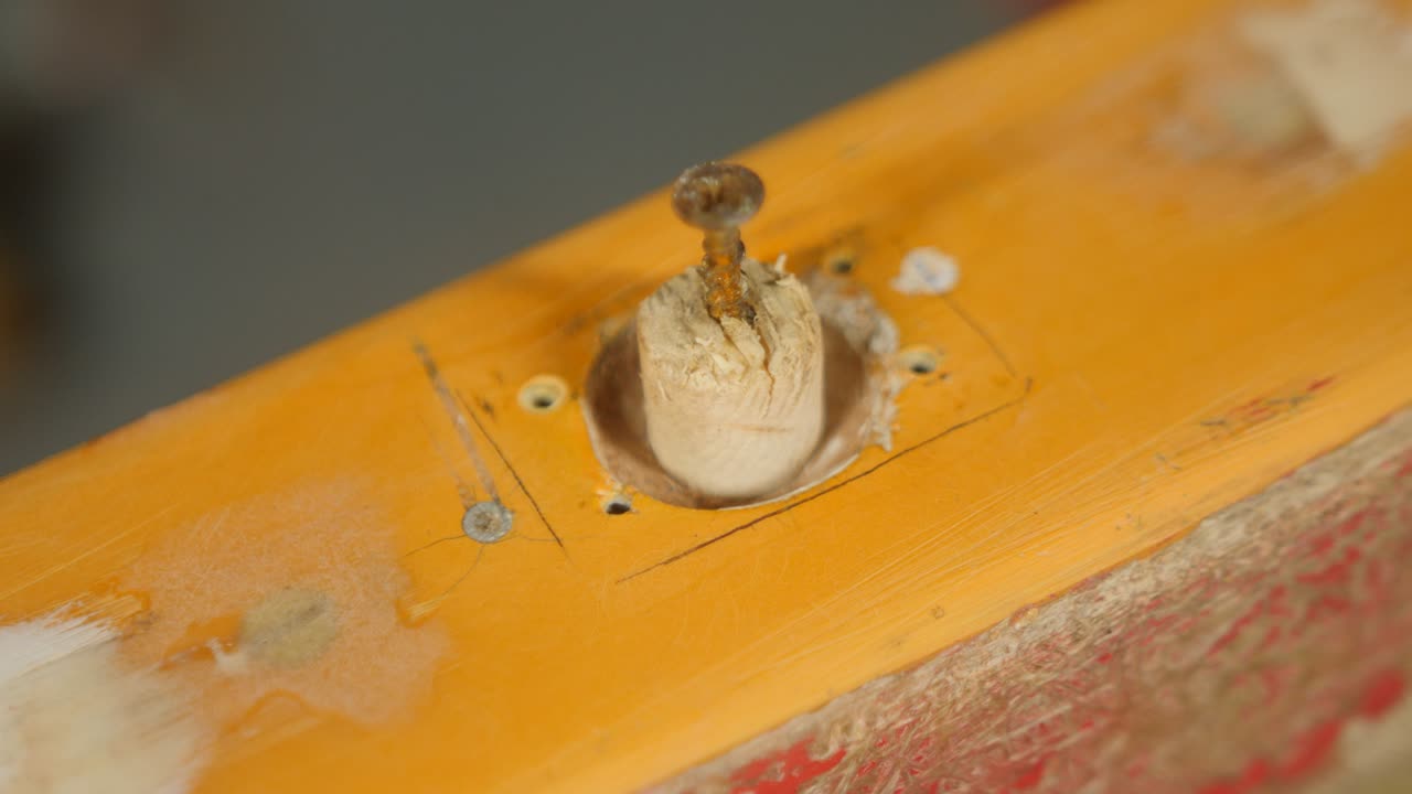 Fitting dowel into rowlock socket before fiberglass repair boat gunwale