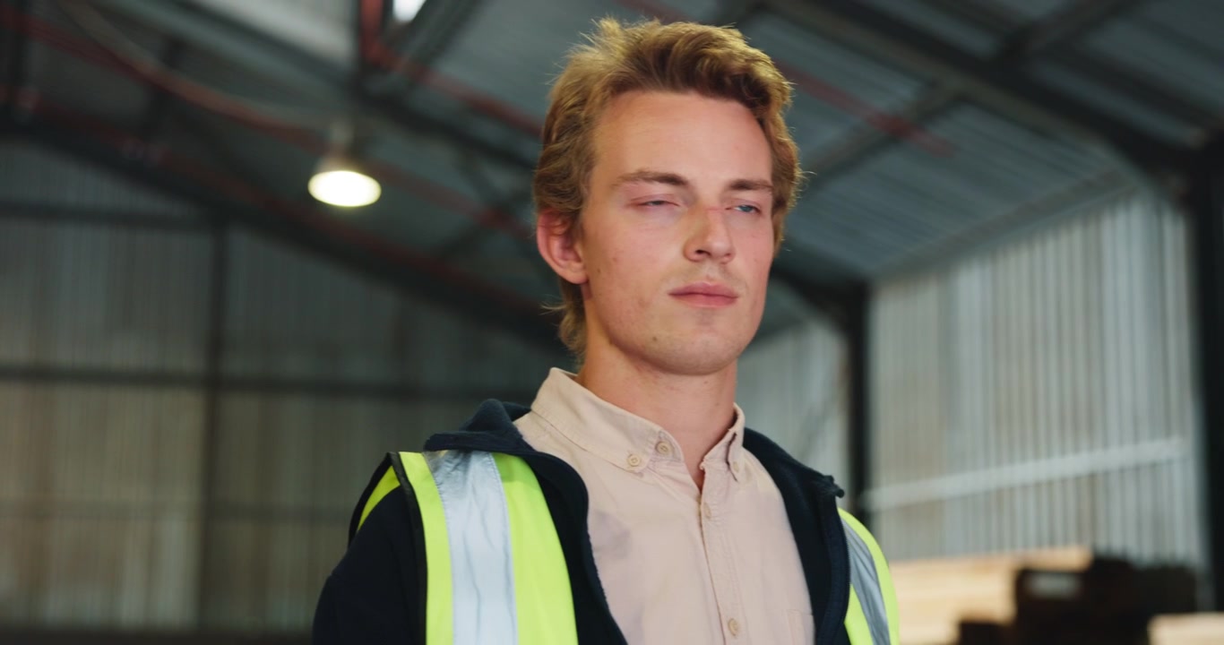 Young Man Wearing High Visibility Vest in Warehouse