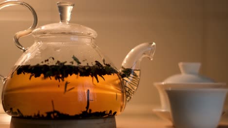 tetera de vidrio con hojas de té