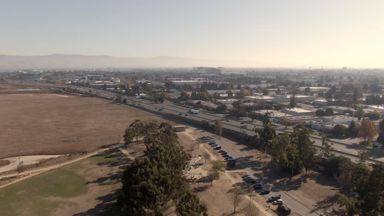 Detailed drone view of the South San Jose tech corridor and Highway 101. Features the intersection of nature, industry, and the fast-paced Silicon Valley infrastructure at 4K resolution