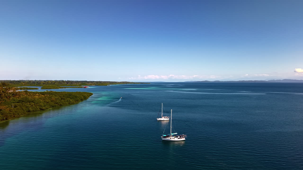 Yachts Floating In The Sea Near The Island Under The Blue Sky In Summer. - aerial shot