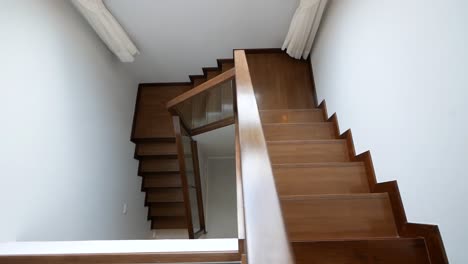 nice and clean shiny wooden stairway and white wall