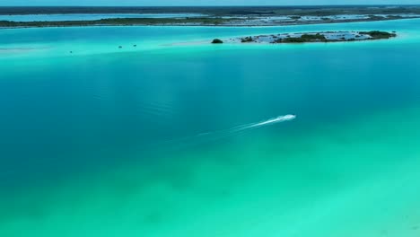 drone aerial of jet ski water sports boat motor driving across bacalar lagoon lake river sandbar quintana roo nature travel tourism holidays inlet channel mexico central america