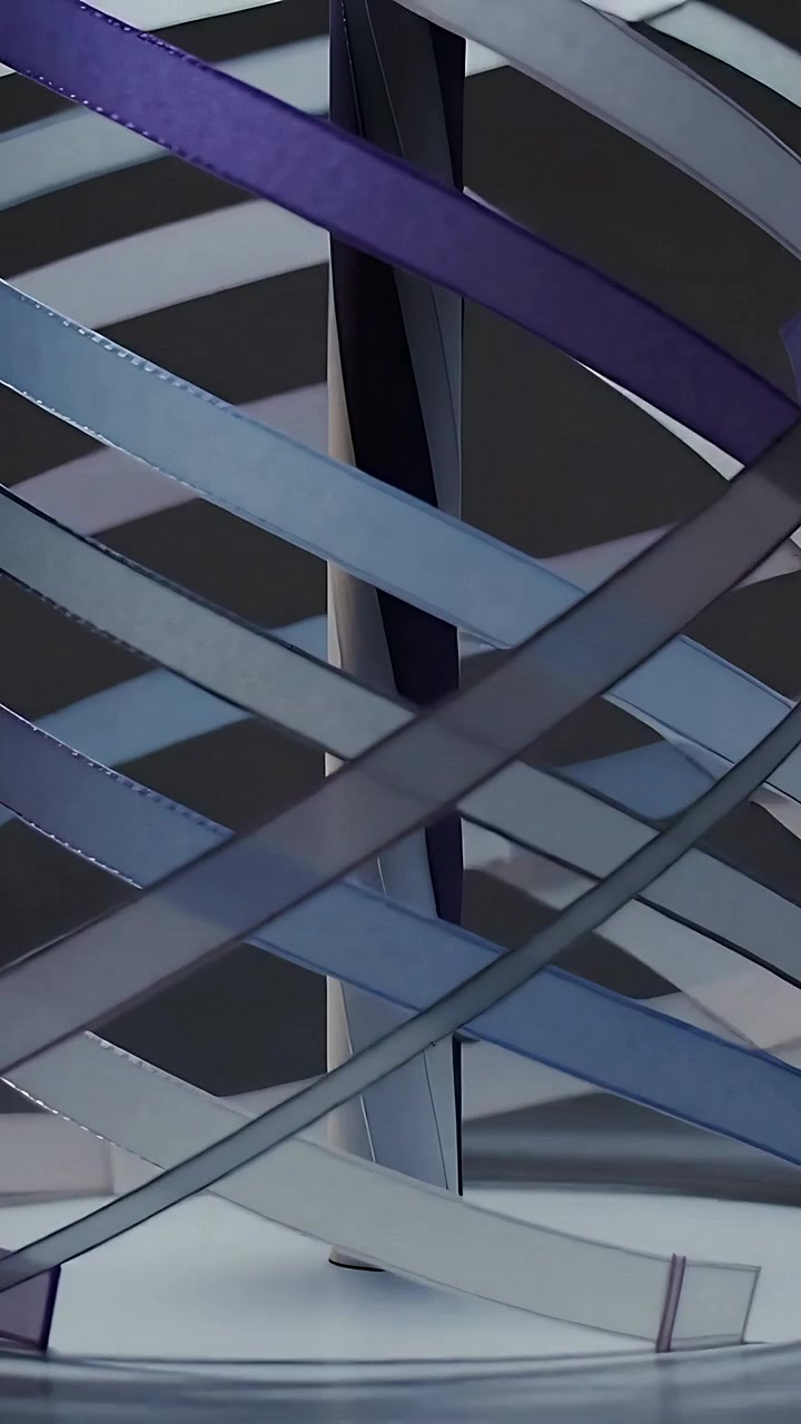 Vertical video: Panning camera downward, curved strips sliding around mast revealing base in studio