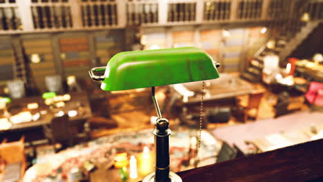 old library interior featuring green desk lamp and scattered books