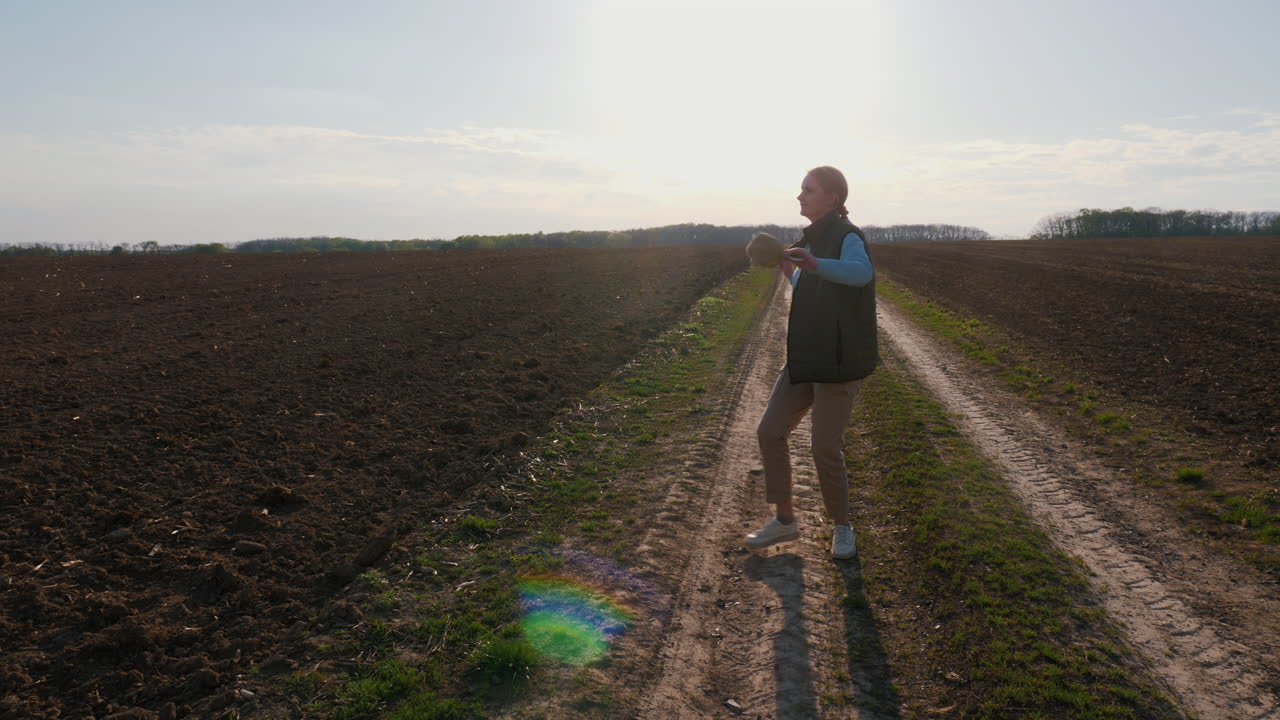 Woman Walking in a Countryside Field