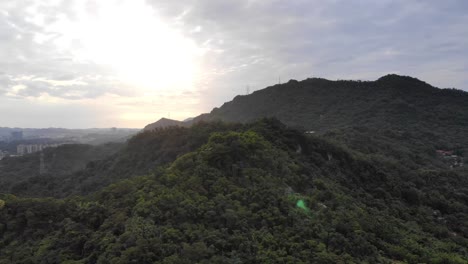 Right-aerial-pan-of-Taipei-city-green-mountains