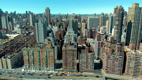 drone slide across manhattan nyc buildings along the fdr drive in the springtime in 4k