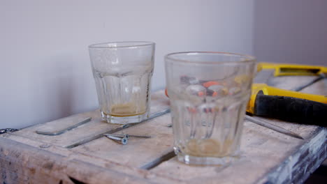 close up of empty drinking glasses on workmans trestle table