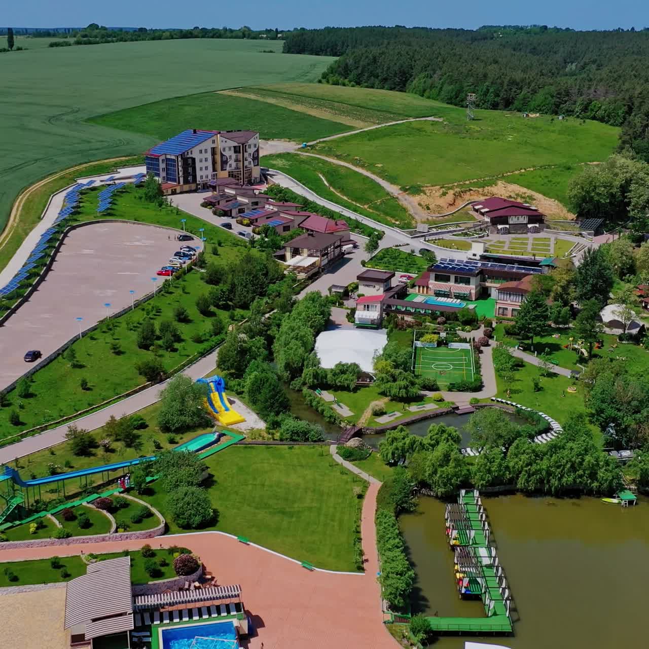 Panoramic view of recreation area. Flying over the modern recreation complex among beautiful nature landscape. Healthy lifestyle. Aerial view.