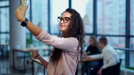 woman taking a selfie in an office
