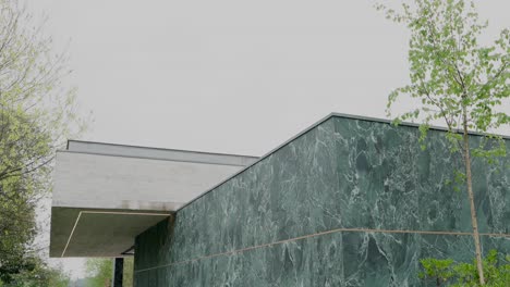 contemporary building with green marble facade and white concrete roof in portugal