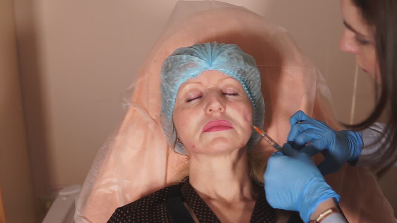 Woman receiving facial injection procedure