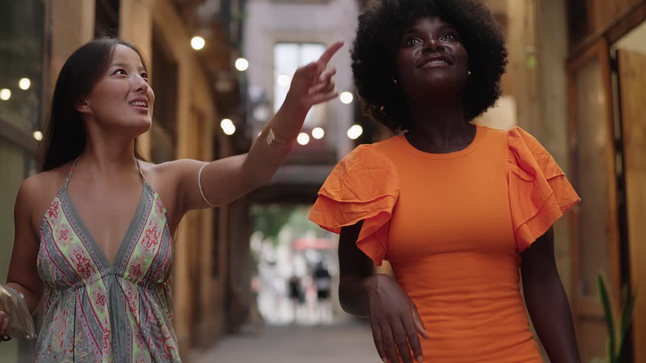 Two women walking down a city street