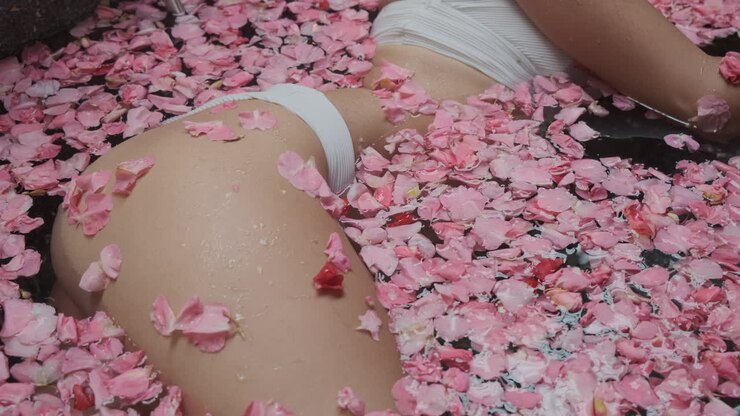 Woman Relaxing in a Rose Petal Bath