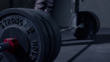 man dropping the bar with high weight to the floor after doing deadlift