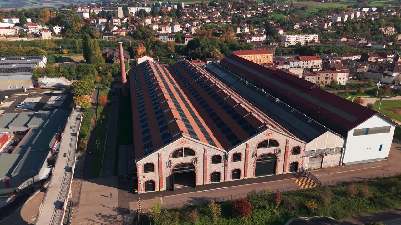 Aerial shot around the building of the new Museum of Urban Art and Street Art in Saint Chamond city in an old steelworks, Loire departement, Auvergne Rhone Alpes region, France