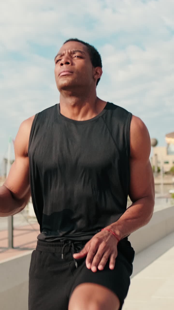 Man Warming Up For a Run by The Marina