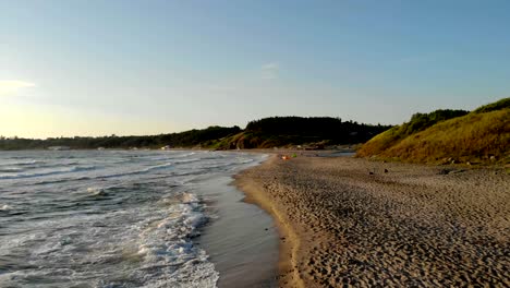 waves crashing on sand at sunrise during vacation at bulgaria.