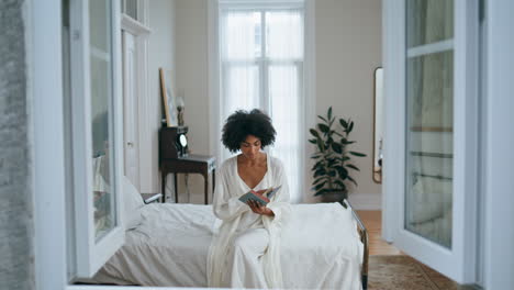 gentle lady reading book luxury bedroom. black hair girl holding favourite novel