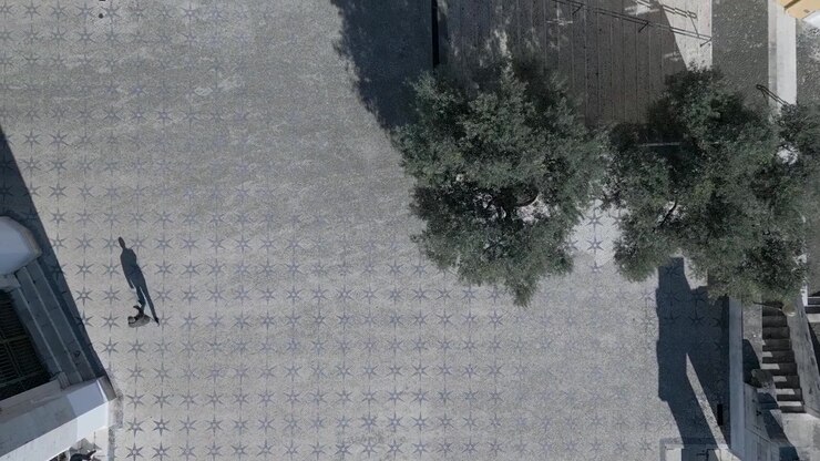 aerial view of tourist walking over cobblestone and enjoying the city in Lisbon, Portugal. Tourist aerial shot.