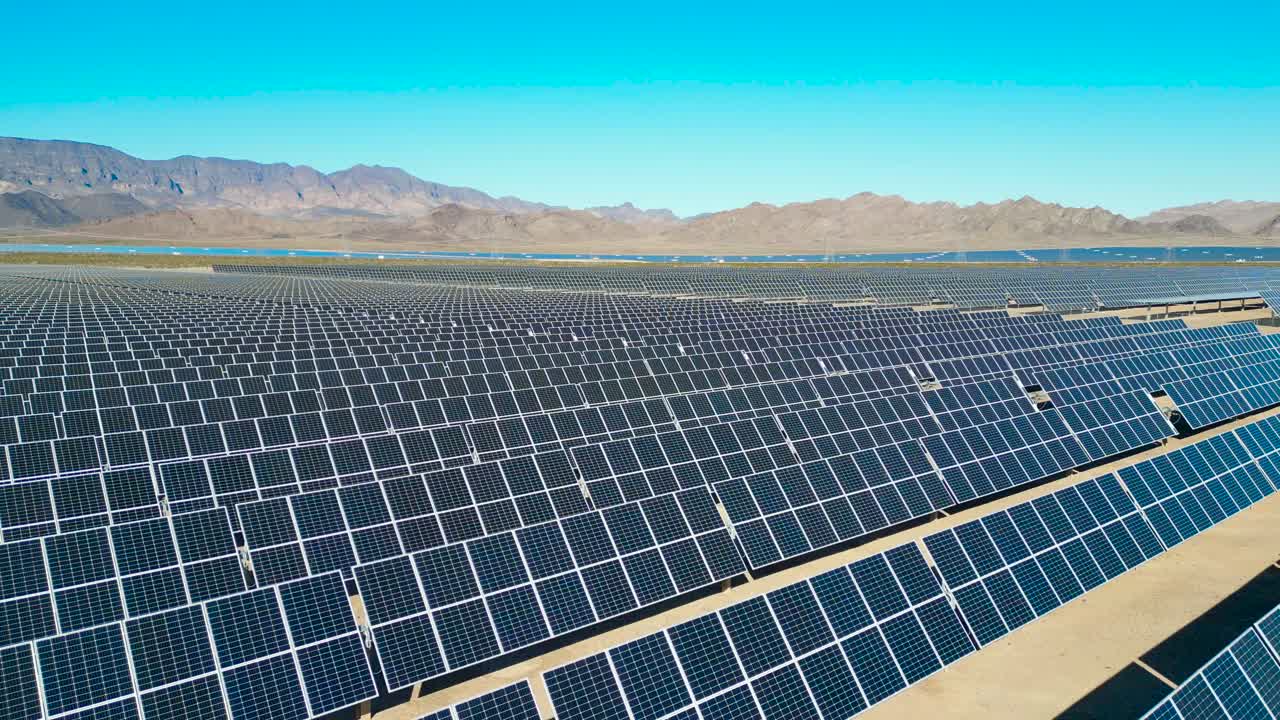 An aerial shot showing an vast solar farm outside of the major city of ...