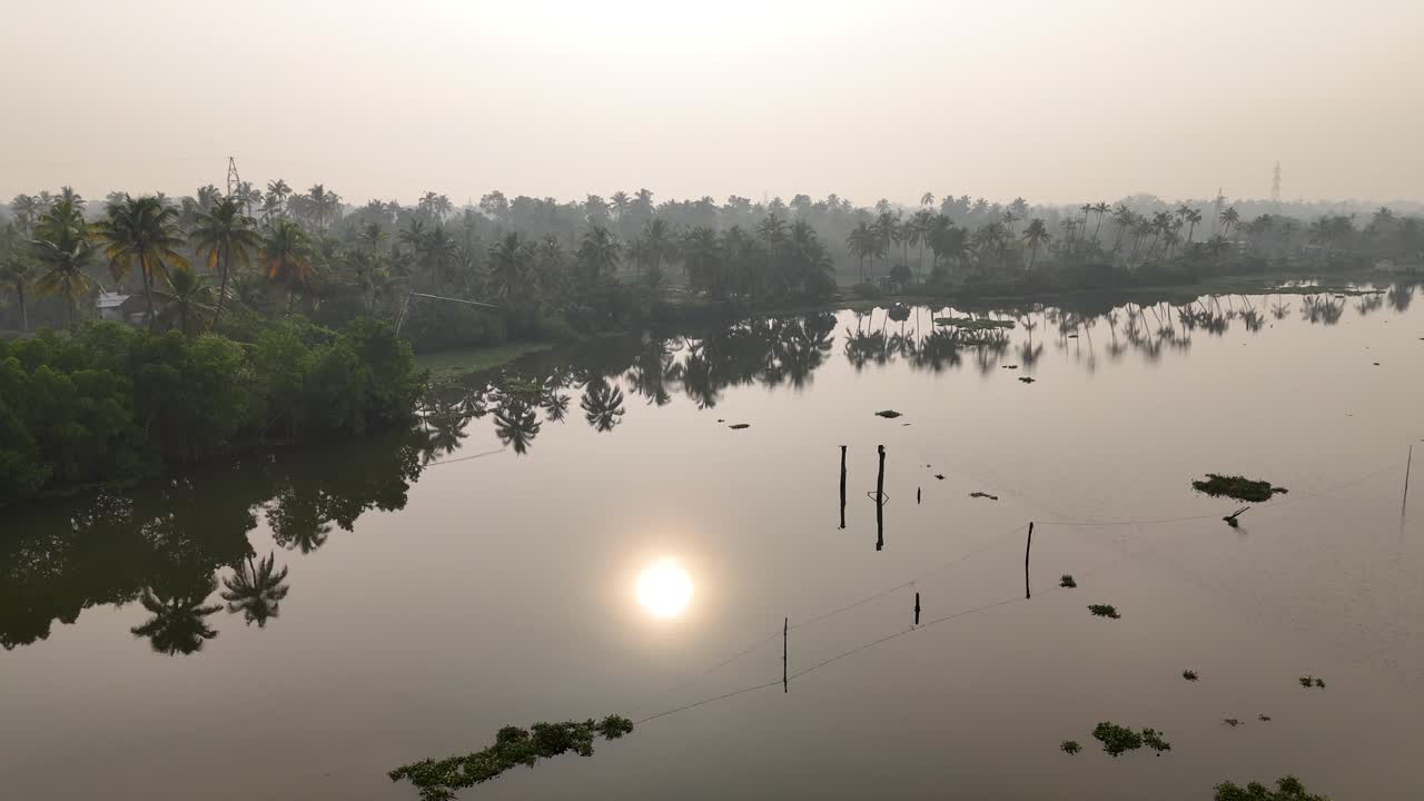 Kerala travel and tourism background, sunrise scene of Kerala backwaters with boat, Tropical river view with morning sunlight through palm trees