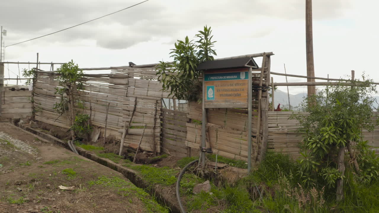 A wooden sign about the importance of irrigation water for production in Imbabura, Ecuador