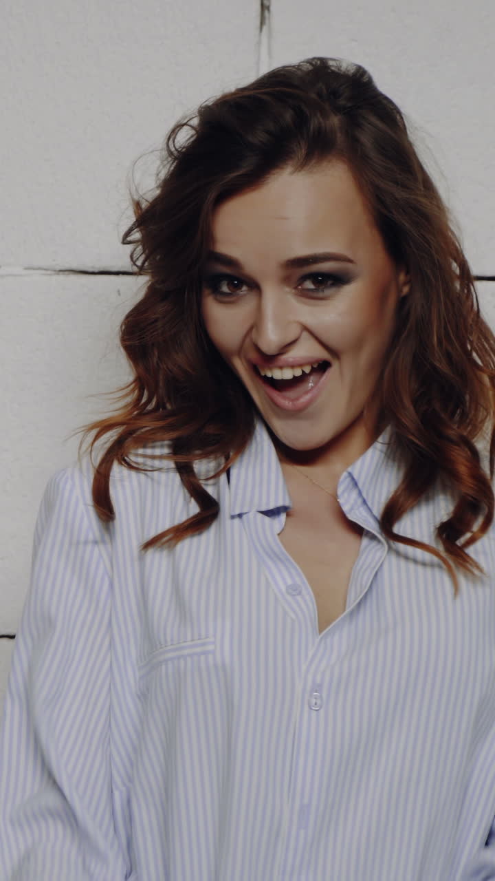 Portrait of a young beautiful brunette with a beautiful make up Vertical video