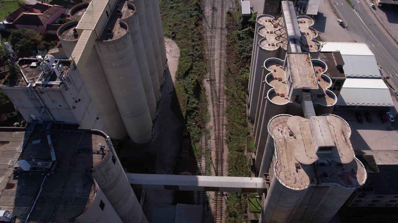 Aerial View of Grain Silos and Railroad Tracks in Industrial Area