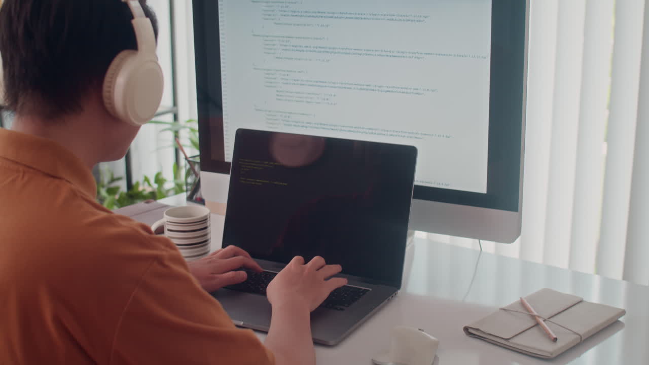 Rear View of Programmer Fixing Bugs in Code on Computer