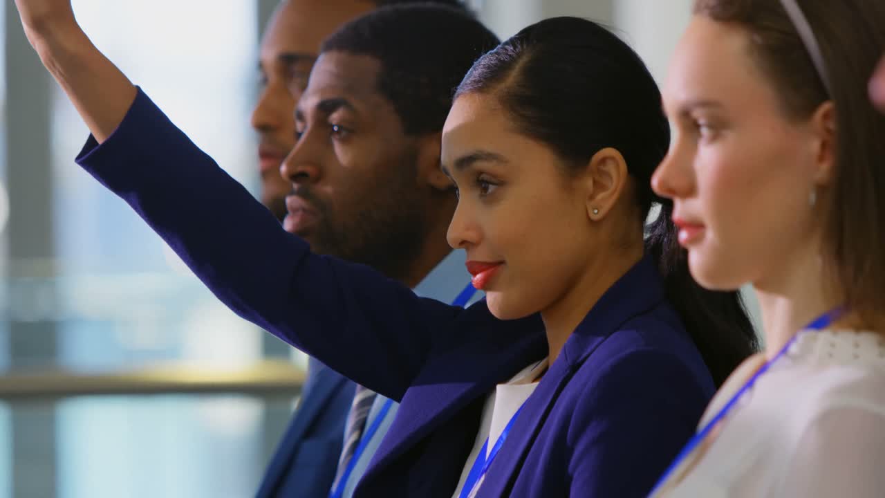 Businesswoman raising hand in the business seminar 4k
