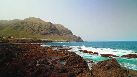 panoramic view of the beautiful volcanic rocky coastline in tenerife, canary islands, spain.
view of the turquoise ocean and waves crushing on the rocks.