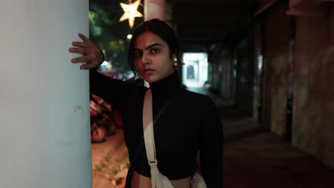 Model-takes-a-photo-shoot-on-the-street-wearing-a-short-black-turtleneck-sweater