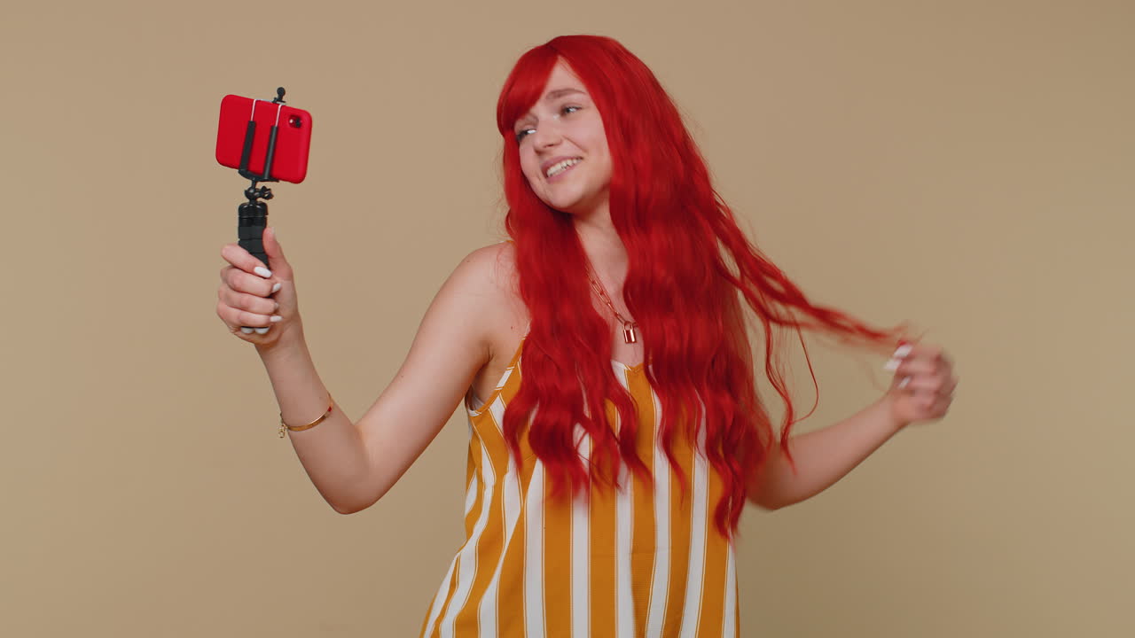 blogger adulta tomando selfies en el teléfono móvil, comunicándose en video llamada en línea con los suscriptores