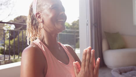 African-American-senior-woman-sitting-indoors,-looking-away-with-smile